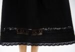 black cotton petticoat adorned with lace trims and pleats