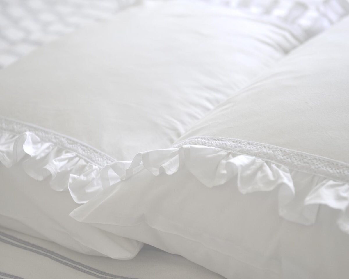 white cotton pillowcases adorned with frills and lace trims