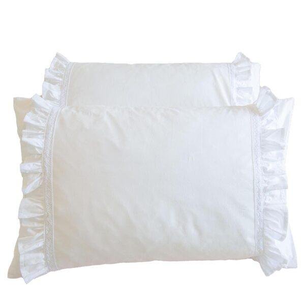 white cotton pillowcases adorned with frills and lace trims