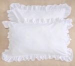 white cotton pillowcases adorned with ruffles all around them