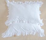 white cotton pillowcases adorned with ruffles all around them