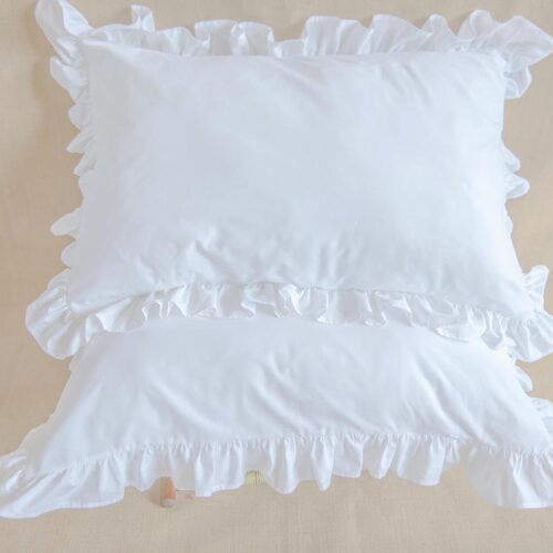 white cotton pillowcases adorned with ruffles all around them