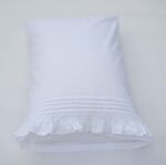 white cotton pillowcases adorned with pleats, frills and a lace trim