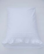 white cotton pillowcases adorned with pleats, frills and a lace trim