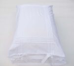 white cotton pillowcases adorned with pleats and bows