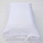 white cotton pillowcases adorned with pleats and bows