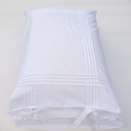 white cotton pillowcases adorned with pleats and bows