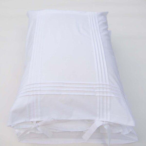 white cotton pillowcases adorned with pleats and bows