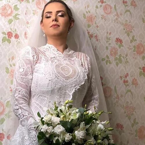 About Us Beautiful bride wearing a gorgeous long sleeve lade wedding dress and a veil both fully handmade. Stunning