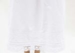 white cotton underskirt adorned with lace trims and pin tucks