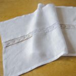 White Linen Table Runner Adorned with a Handmade Lace Trim