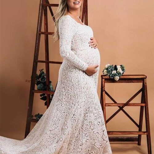 beautiful pregnant bride wearing a lovely bespoke handmade long sleeve lace wedding dress with a mid-sized train