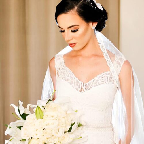 beautiful bride wearing a fully bespoke handmade lace veil over her gorgeous handmade lace wedding dress