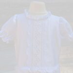 pristine white cotton girl holy communion dress embellished with gorgeous handmade lace trims