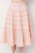 Model wearing a gorgeous peach cotton flounce skirt lavishly adorned with bobbin lace trims