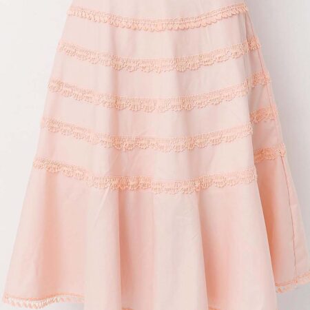 Model wearing a gorgeous peach cotton flounce skirt lavishly adorned with bobbin lace trims