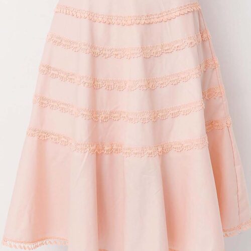 Model wearing a gorgeous peach cotton flounce skirt lavishly adorned with bobbin lace trims