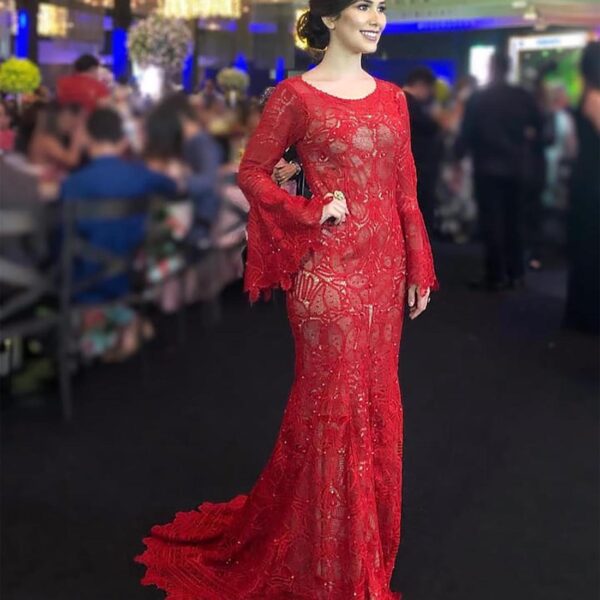 beautiful tall woman in a catwalk wearing a gorgeous bespoke handmade red bridesmaid dress with long sleeves