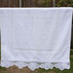 White Bathroom Towel Set: bath towels, hand towels and bathmat adorned with an edging handmade lace trim